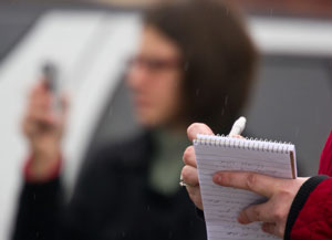 Reporter taking notes in a notebook